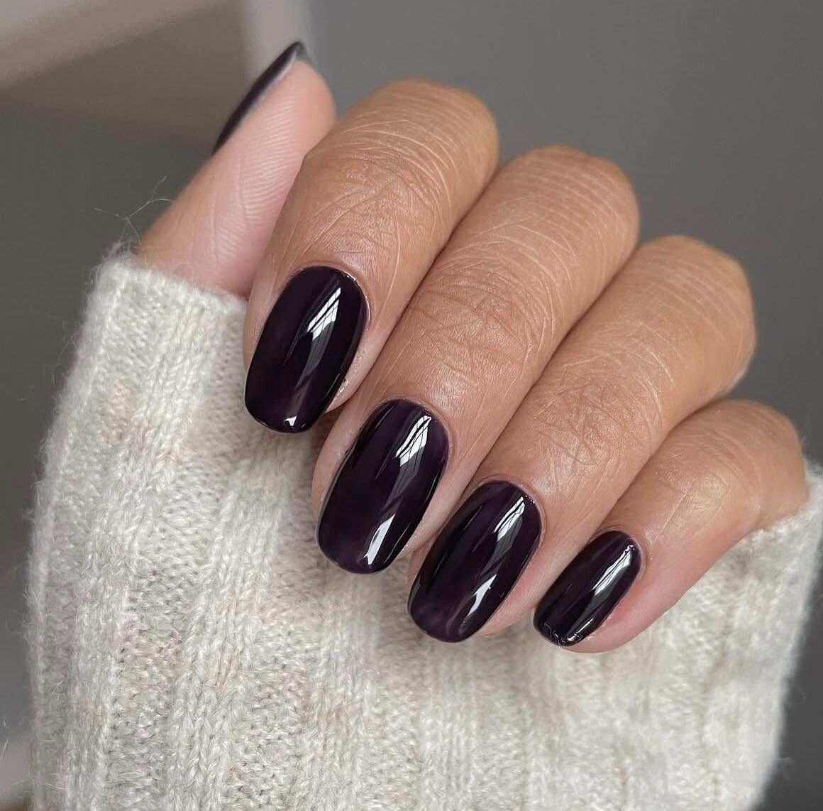 High-shine deep plum gel manicure on squoval nails